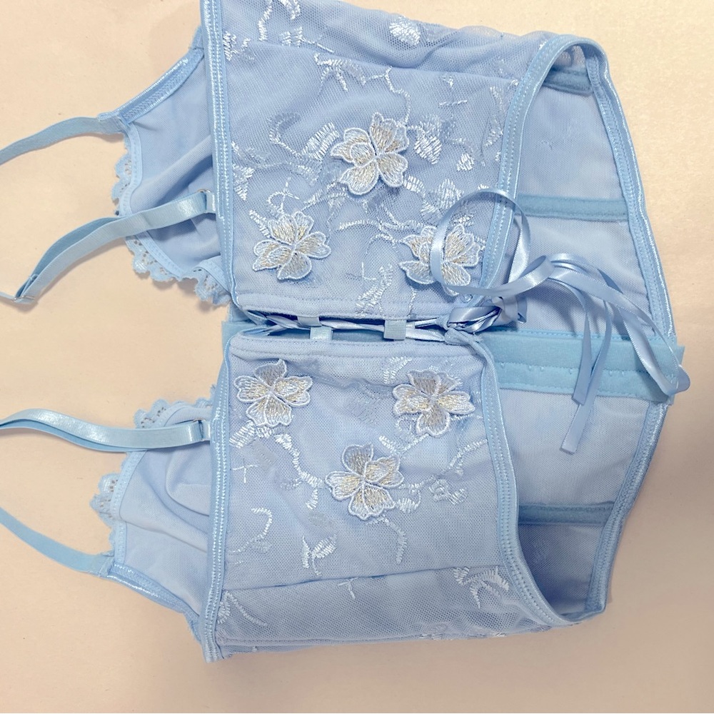 Detailed blue crop top shirt.